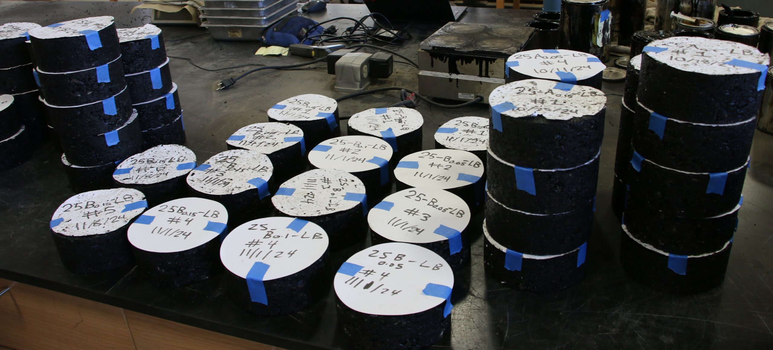 Asphalt pucks are lined up for further testing