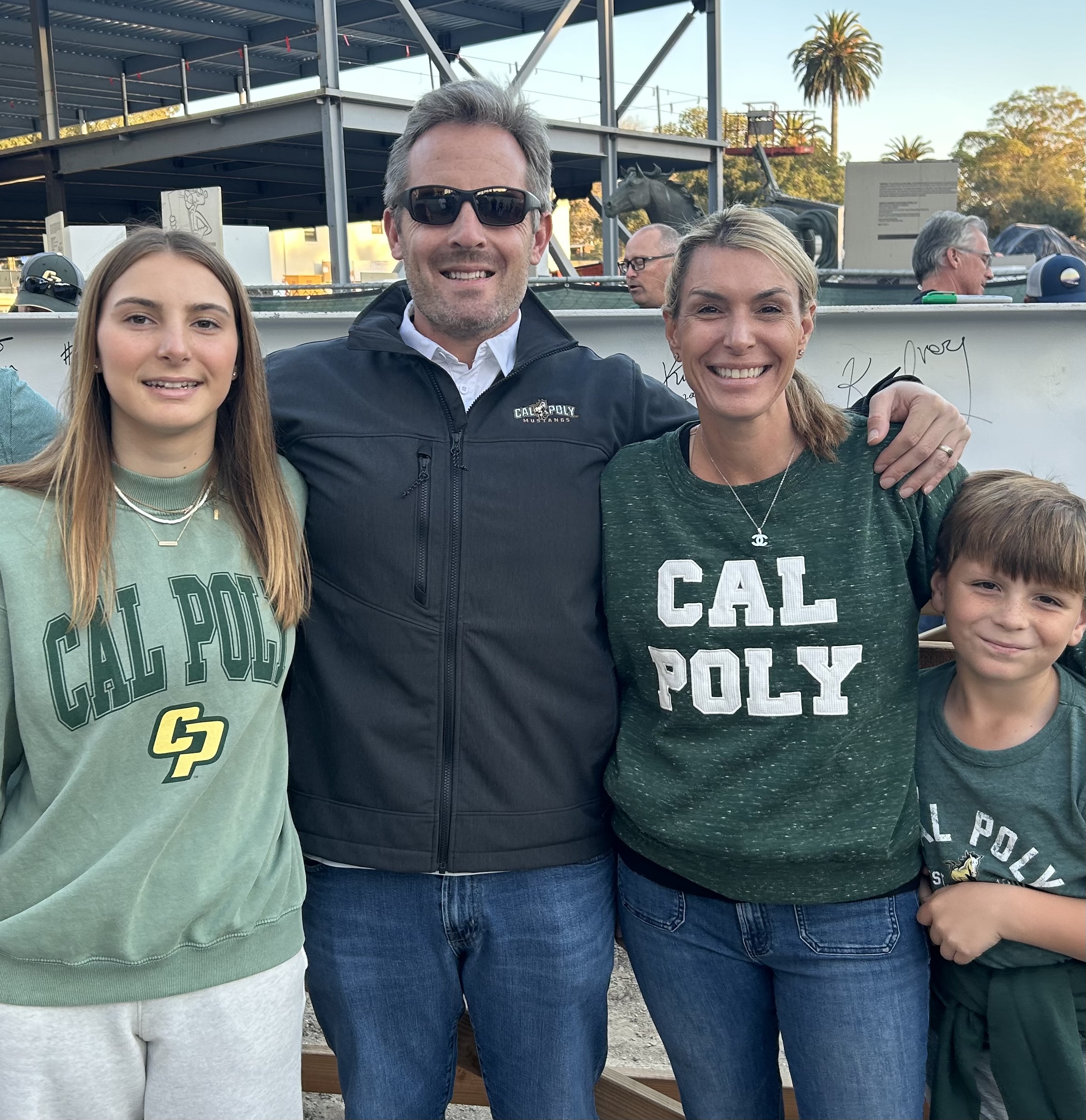 Kelly Turbin and his wife and kids at the football stadium