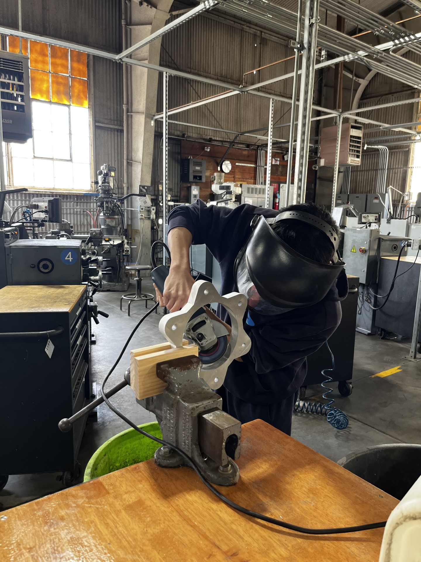 A student working in a machine shop.