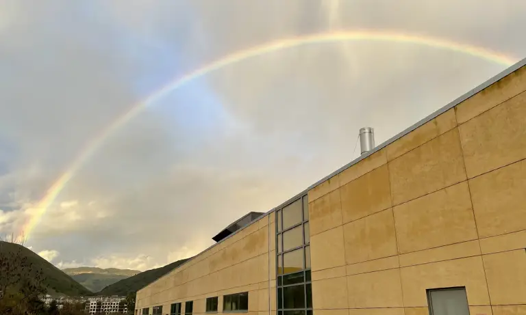 A rainbow over a building