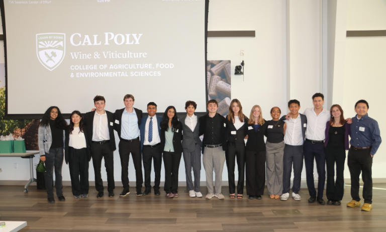 A group of students at a competition posing for a photo.
