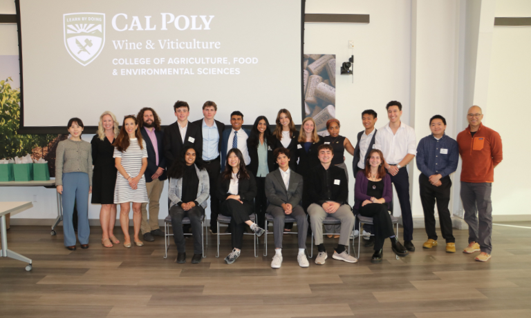 A group of student participants posing with faculty mentors at the 2025 Change the World Challenge.