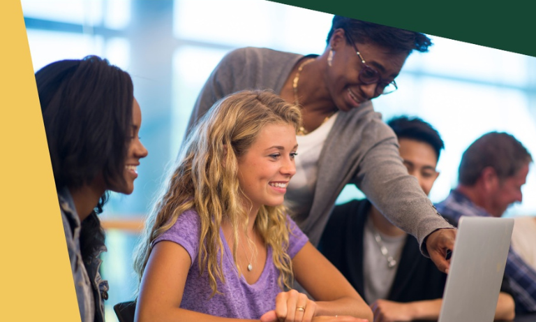 A mentor showing a student something on a laptop.