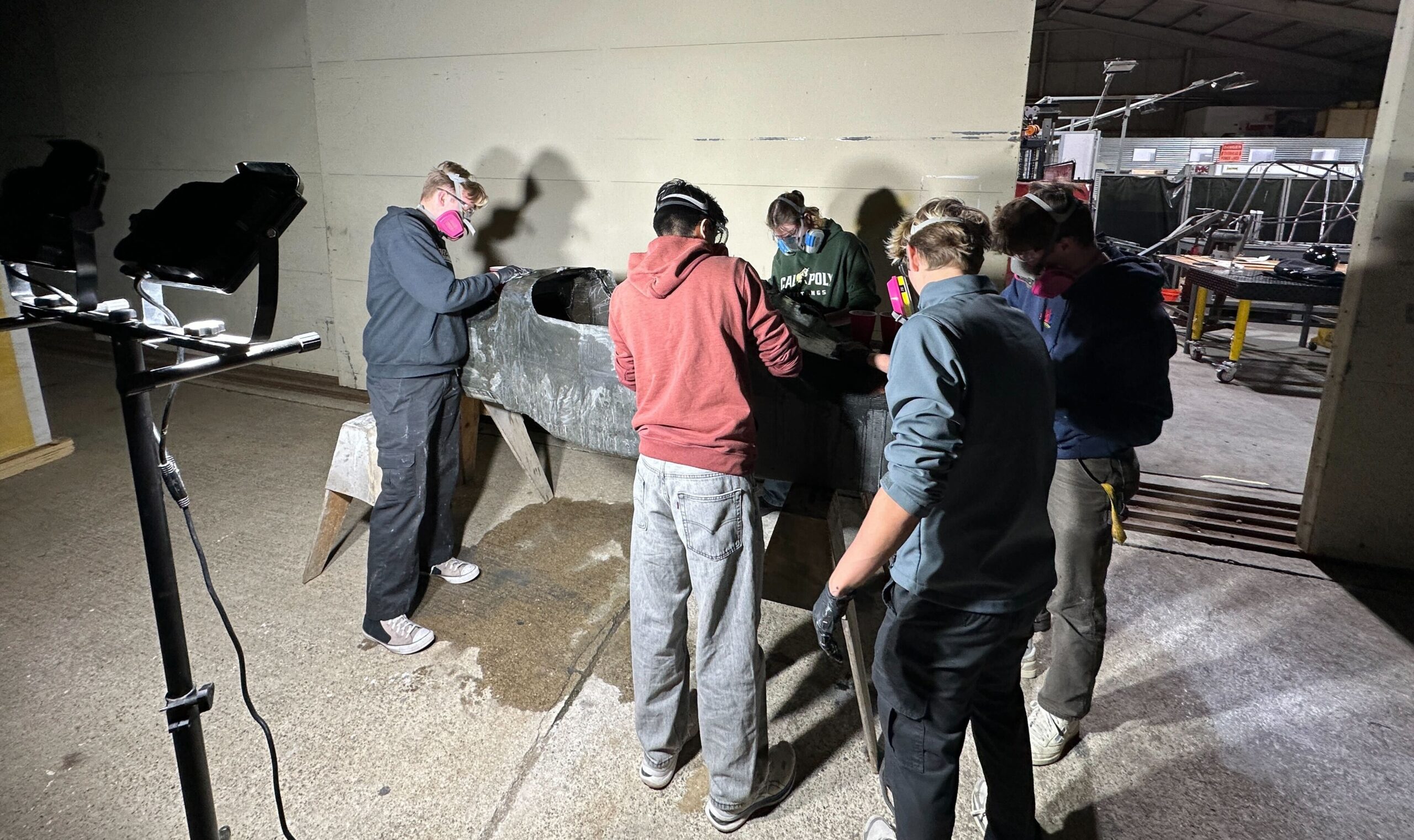 Members prep the carbon fiber body of the car