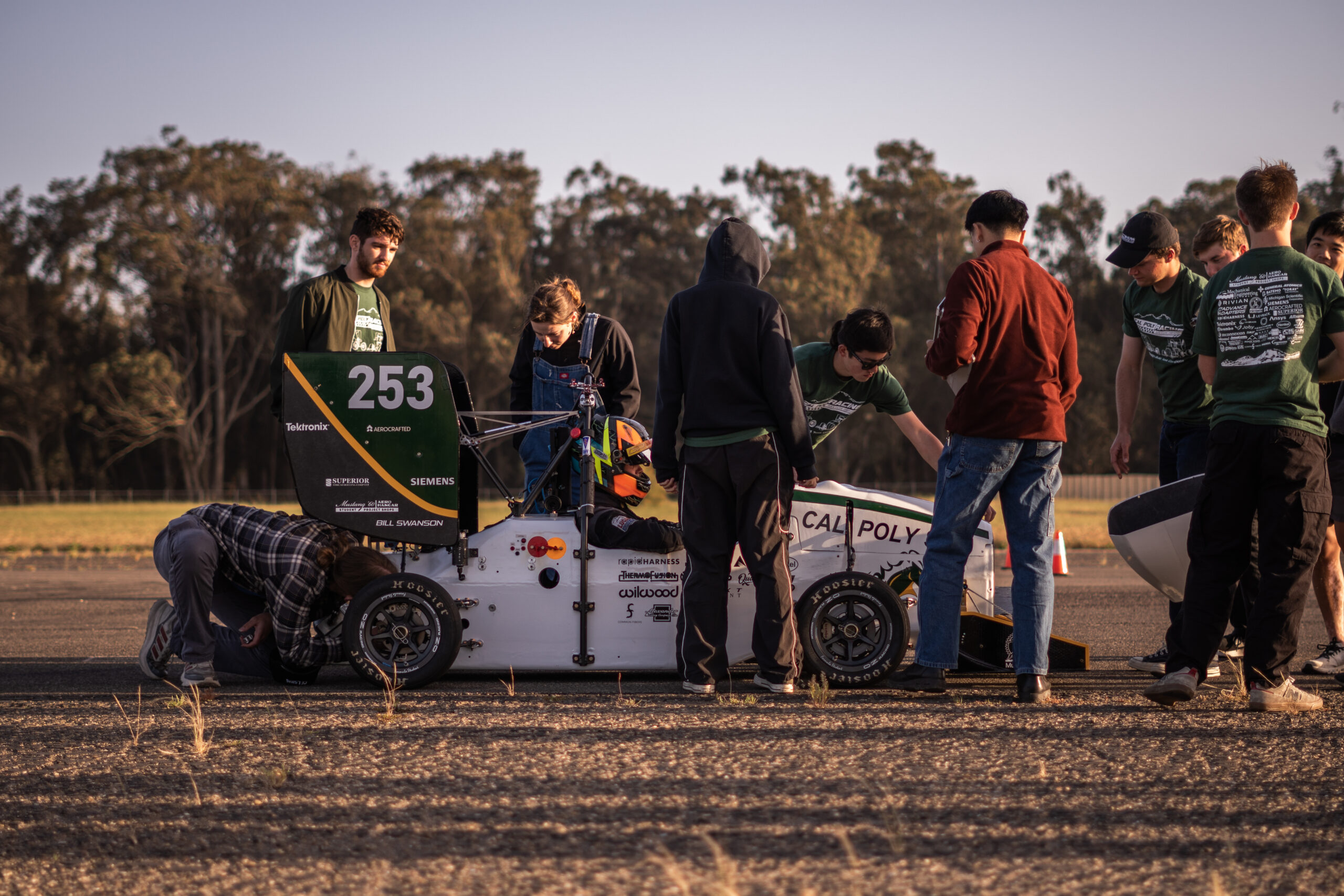 Team members check out the car during a test session