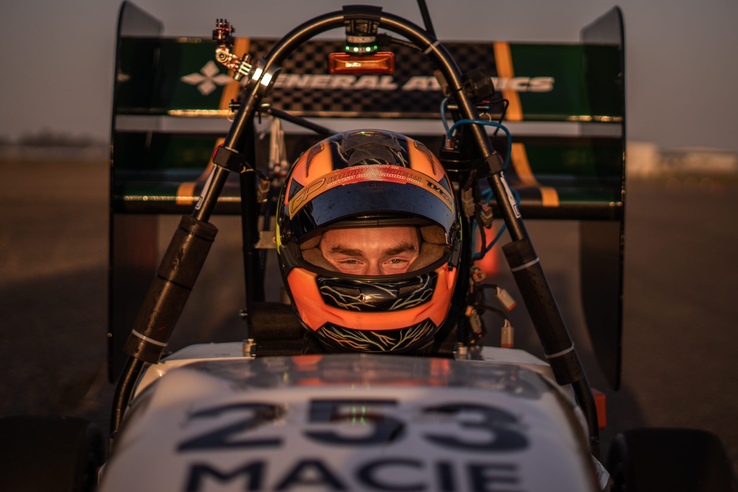 Race car driver seated behind the wheel