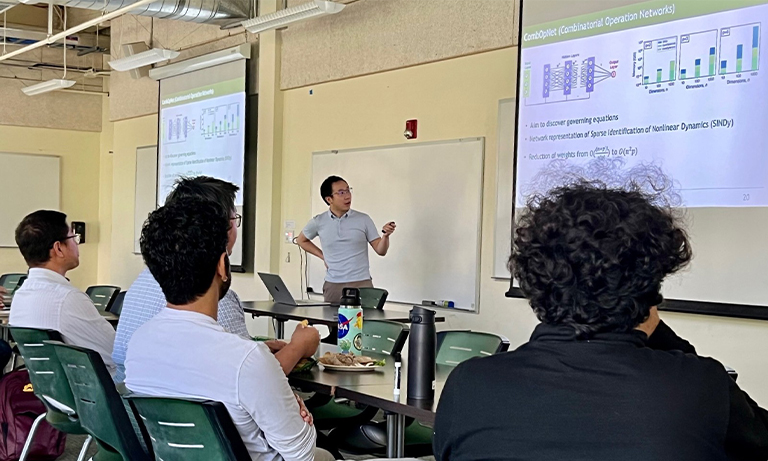 Professor pointing to slide during presentation