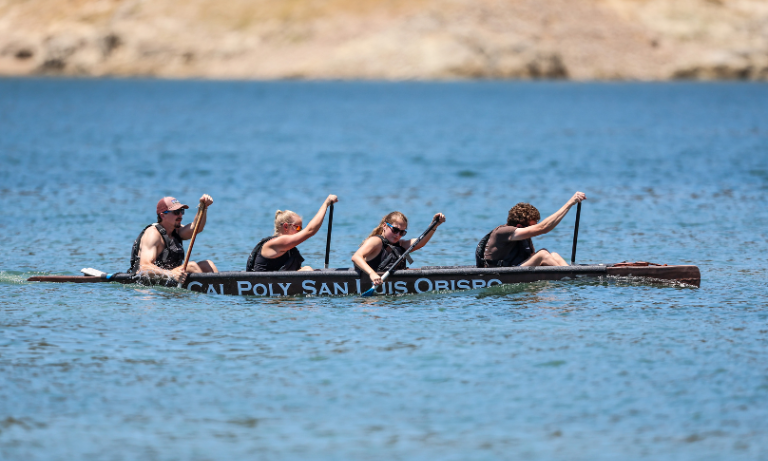Students racing on a concrete canoe