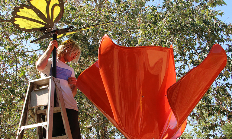 Student installs poppy sculpture in the Botanical Garden
