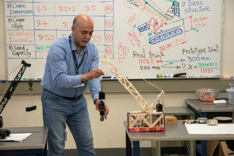 Professor Elbarbary tests the load capabilities of student-made cranes