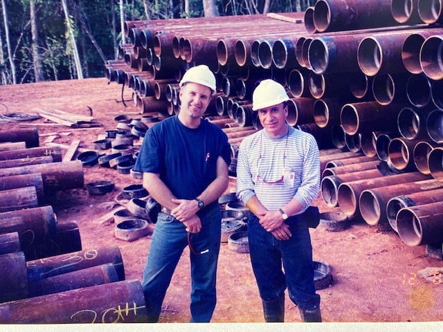 Two men in hard hats at a pipeline construction site