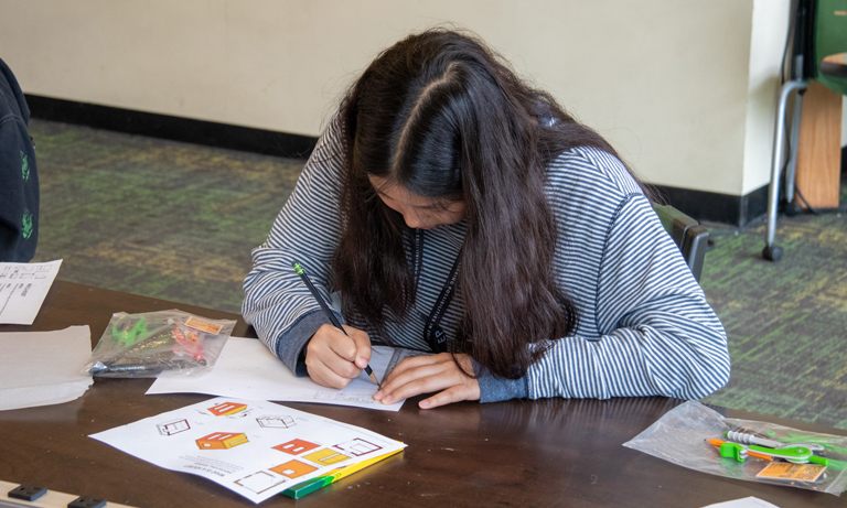 student sketching dream home