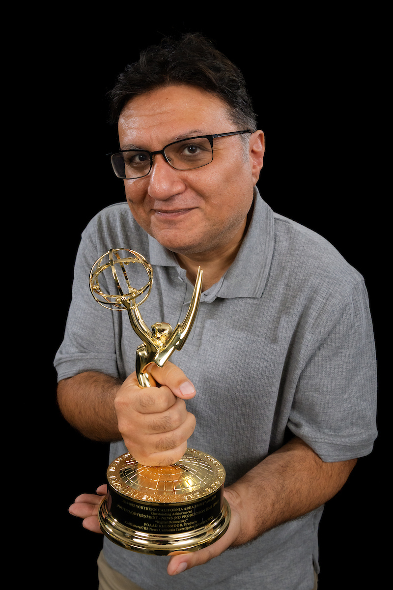 Professor holds his personalized Emmy statuette