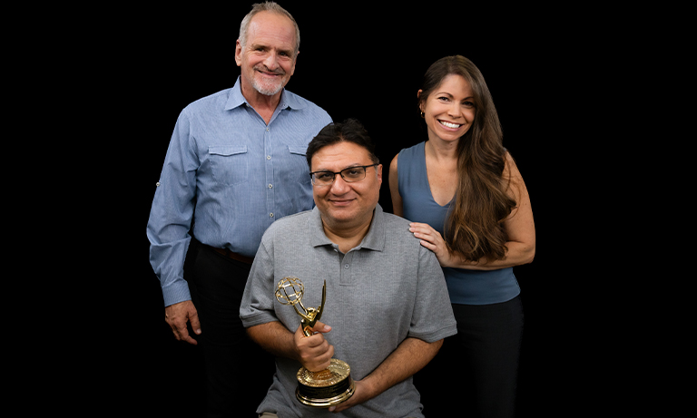 Trio poses for a portrait with Emmy