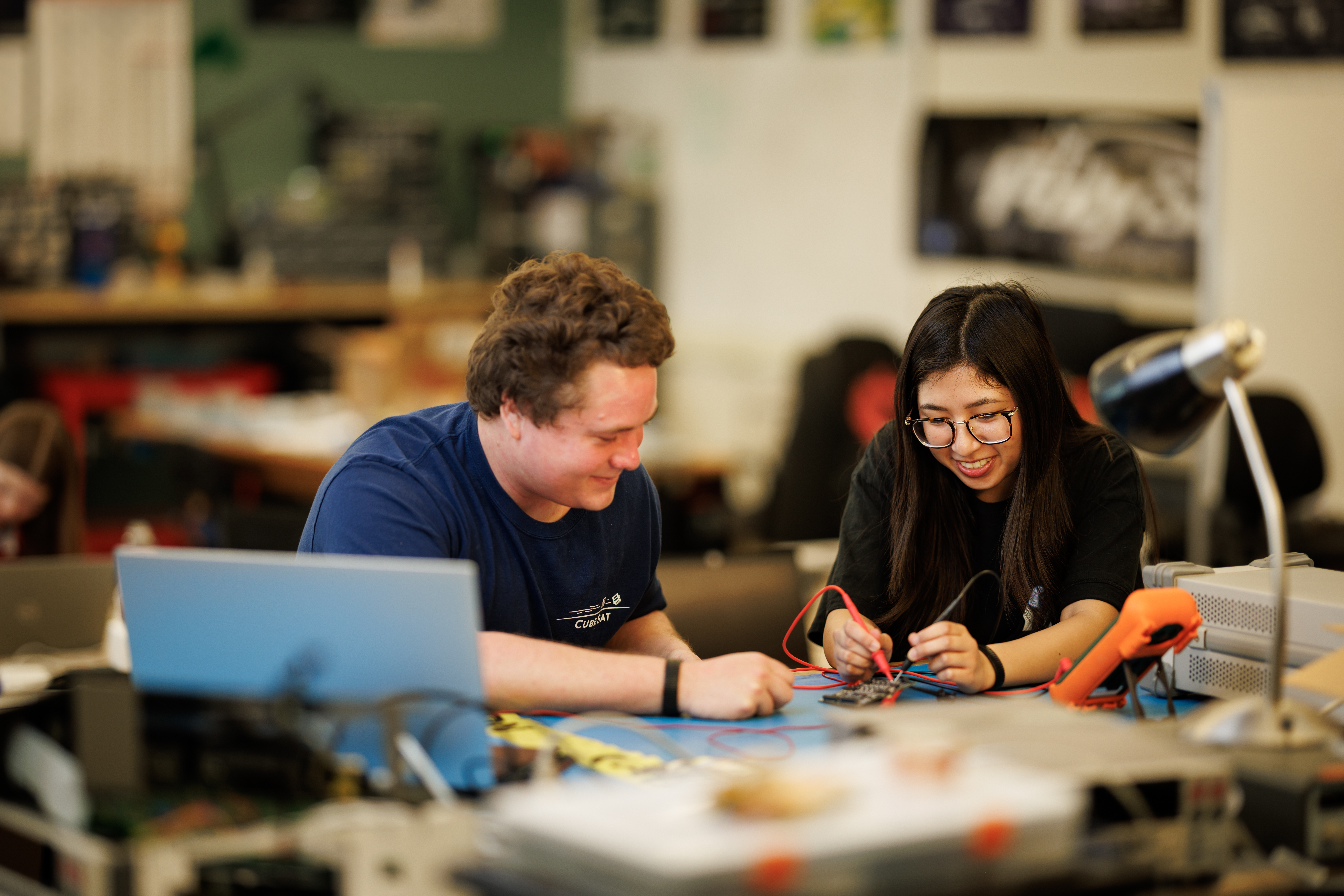 Students work on a payload interface board for the SAL-E CubeSat