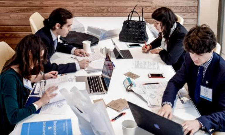 A group of people working at a desk