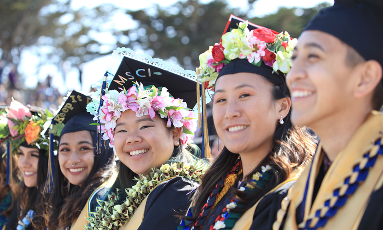 A group of students sitting in their seats at a commencement ceremony