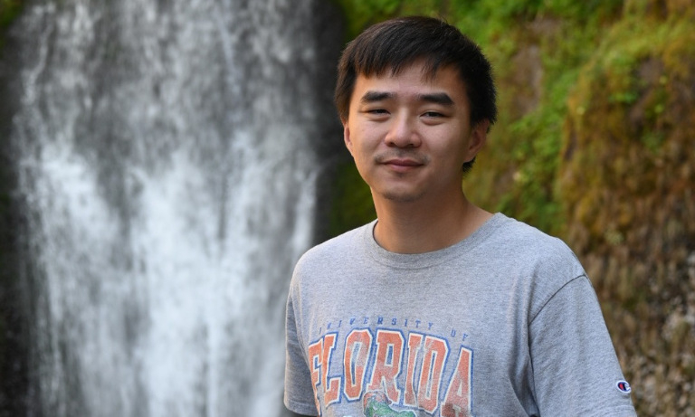 Assistant Professor Jiun-Yao Cheng in front of a waterfall