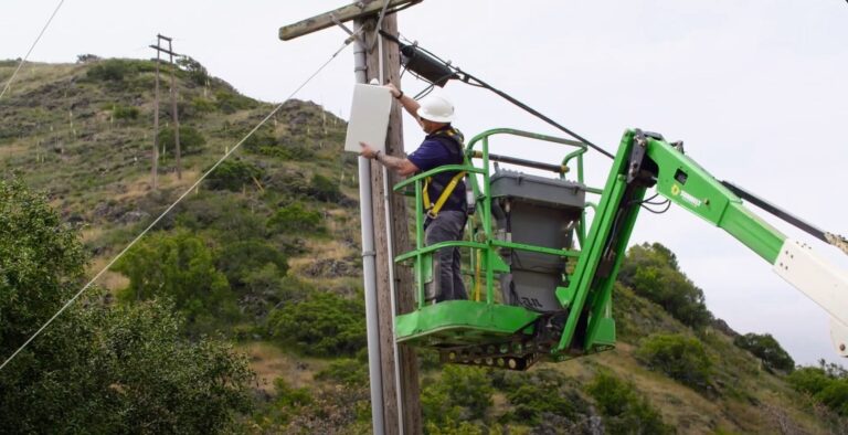 Technician installs equipment to expand private wireless connectivity in Poly Canyon