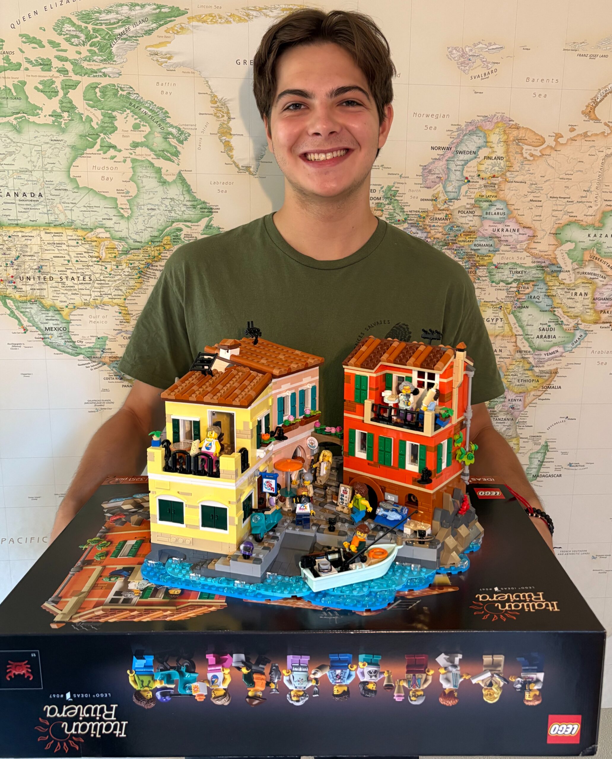 Student holding Lego set and box