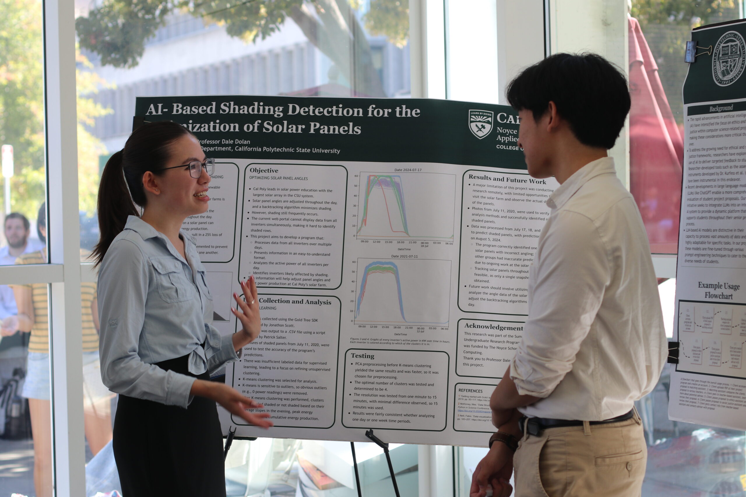 Two students talking in front of research posters