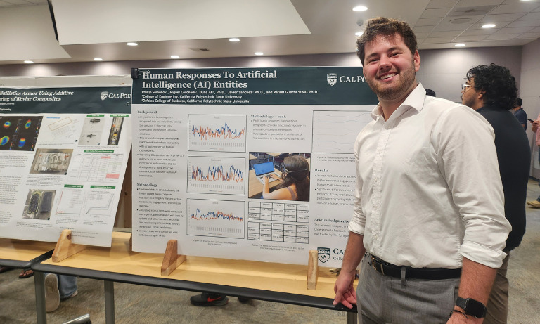 A student smiling at the camera and posing in front of a research poster at the 2024 SURP Symposium