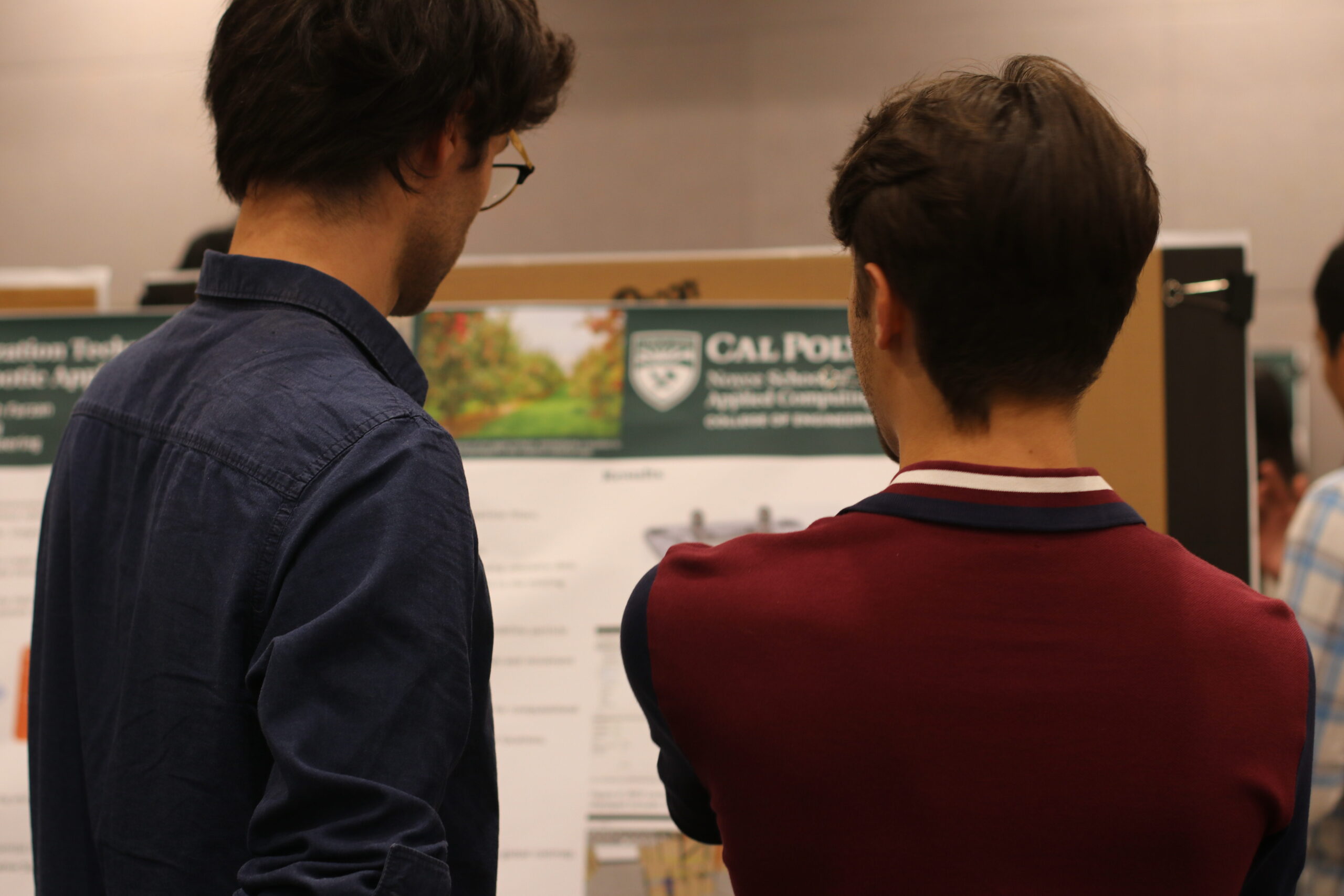 Students looking at a poster at the Summer Undergraduate Research Program