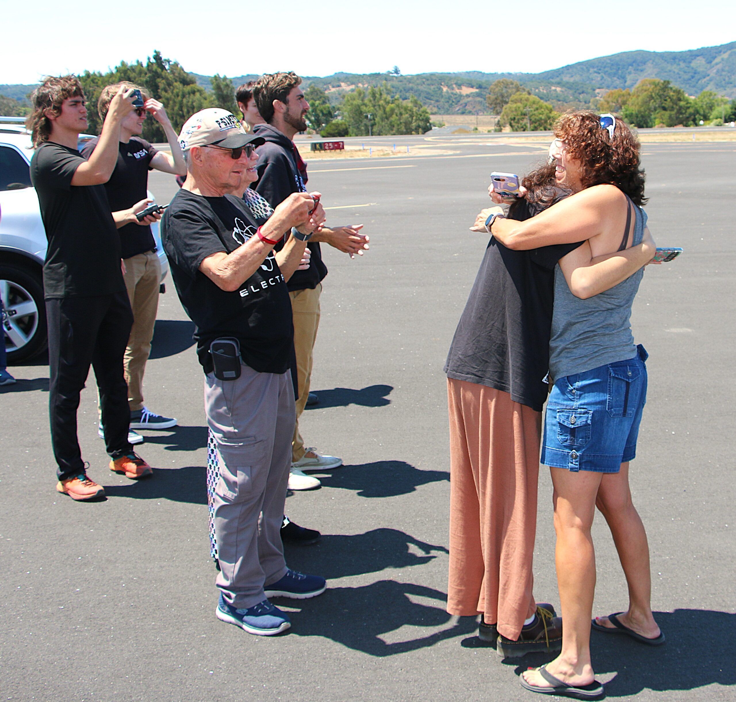 Professor's wife and daughter hug as he takes off for the first time