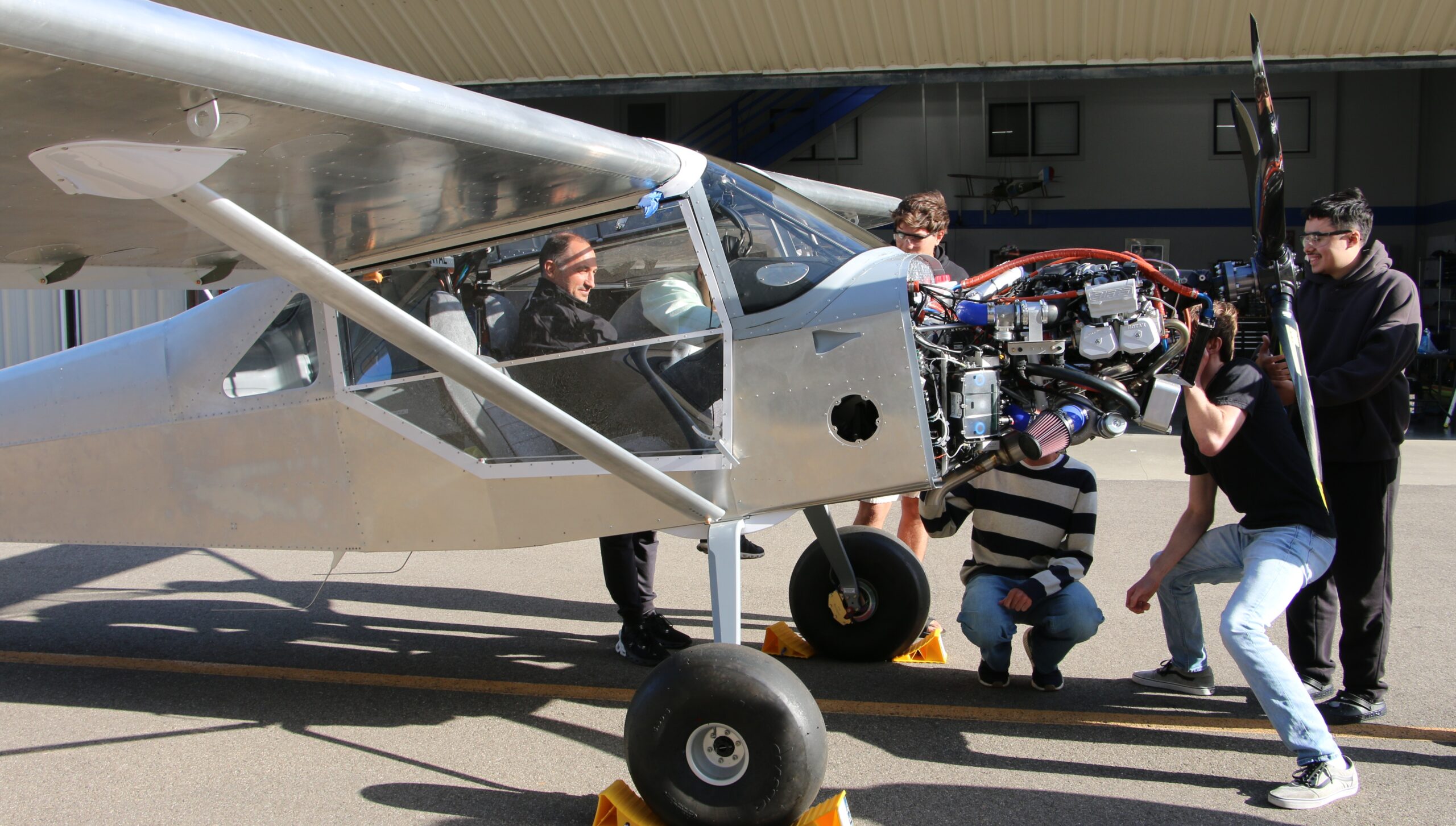 Professor and students perform final checks before starting the engine for the first time