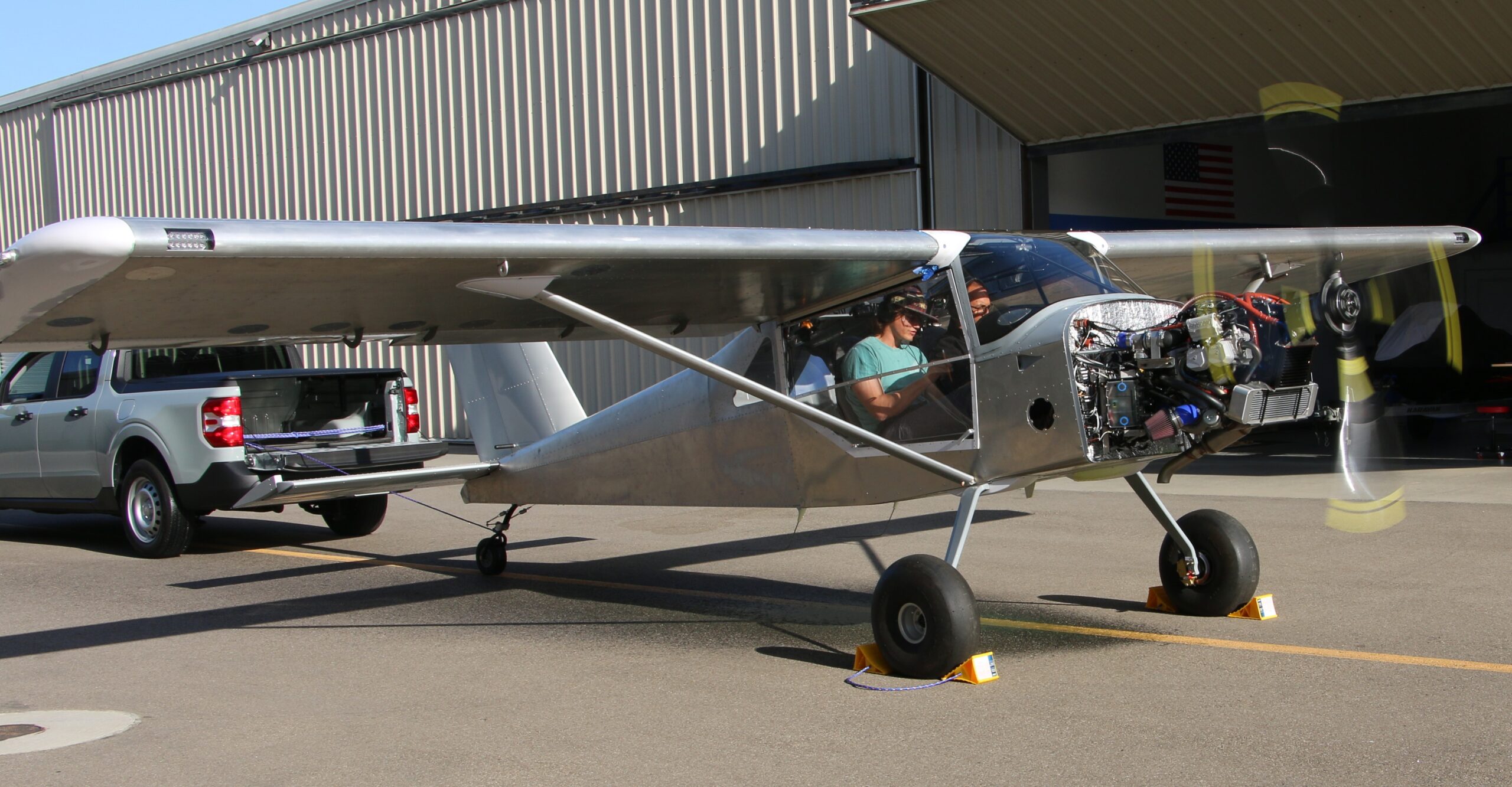 Student and professor run checks after starting the plane for the first time