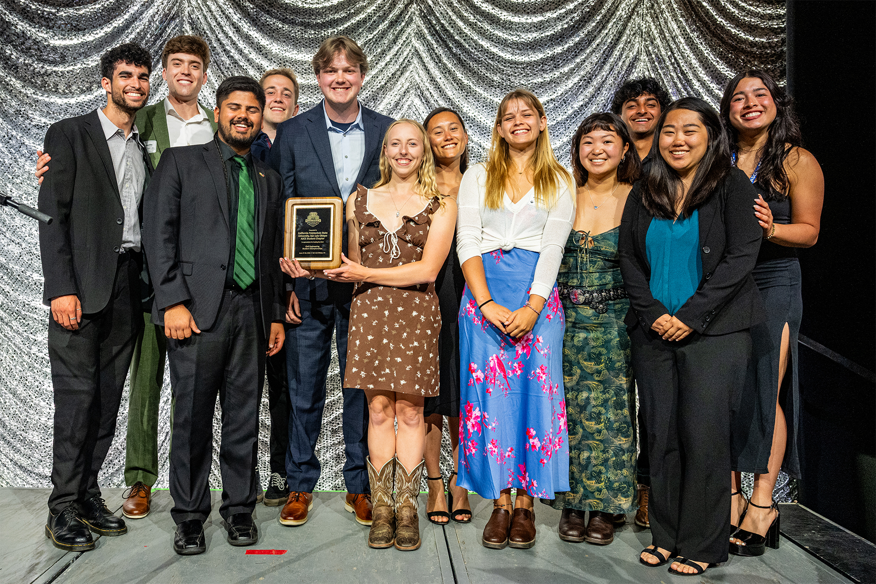 Cal Poly's student committee gathers for a group photo with their plaque in recognition of hosting the event