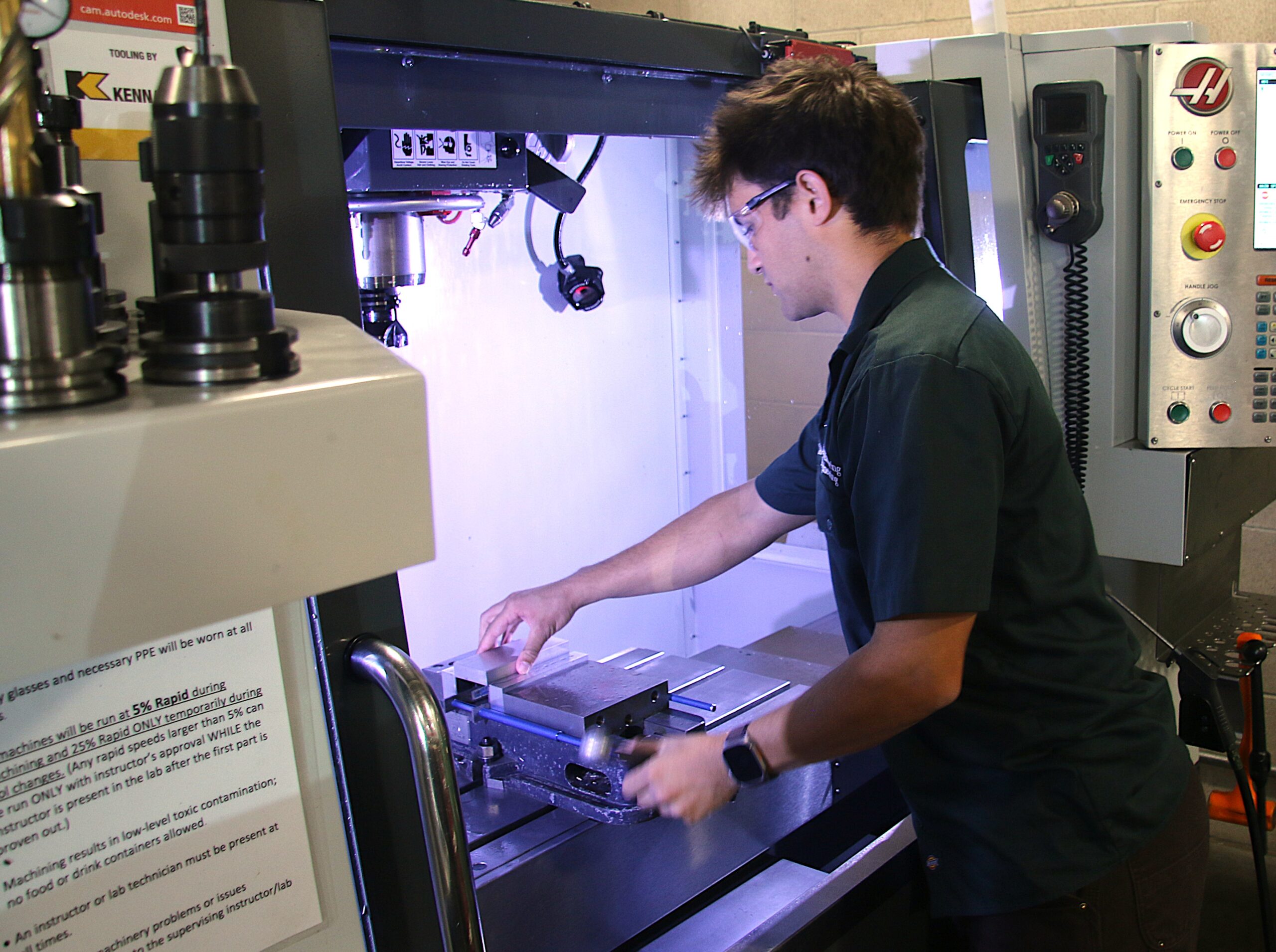 Student lab tech works with CNC machine