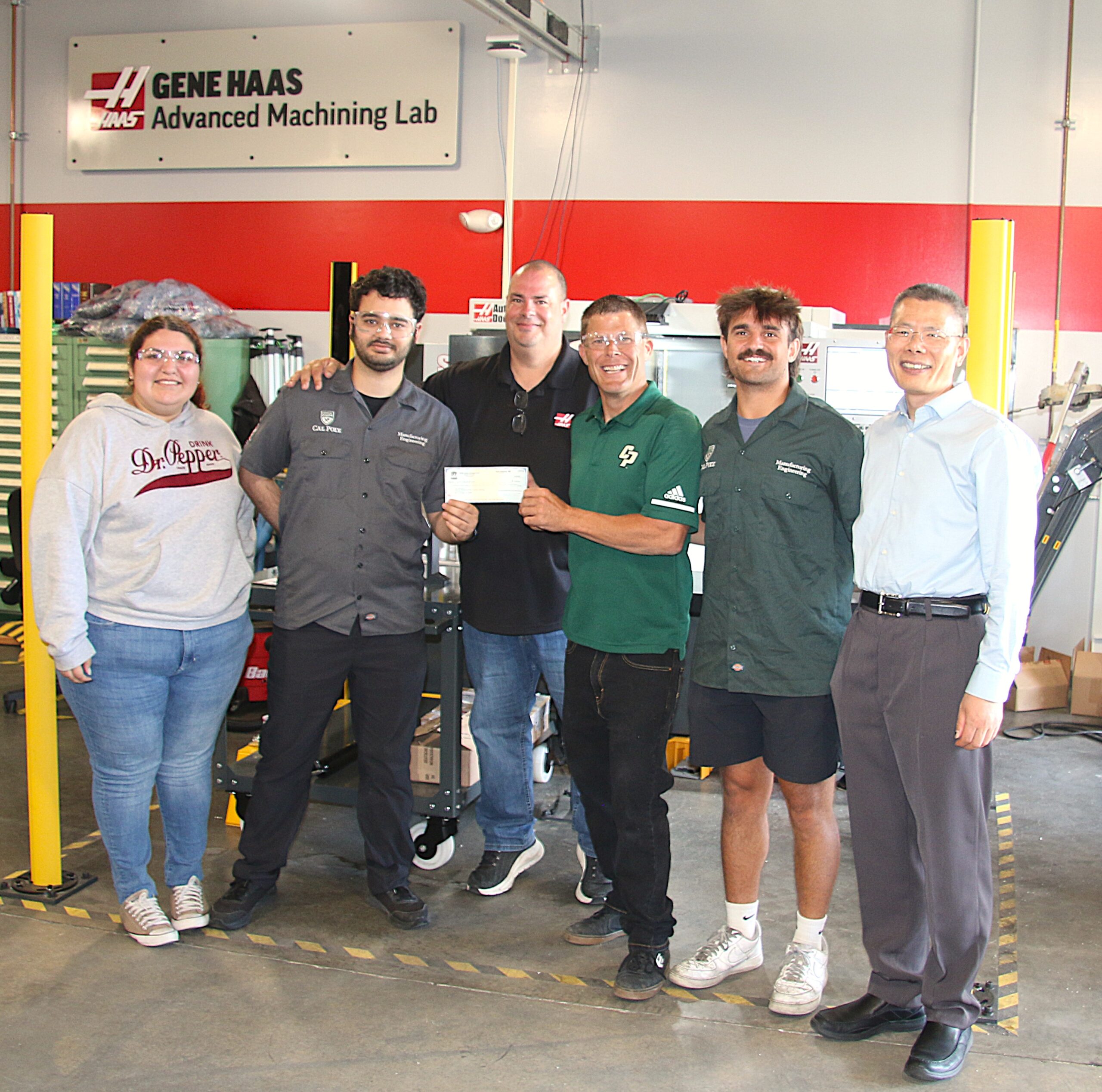 Students and faculty gather to receive a grant from Haas