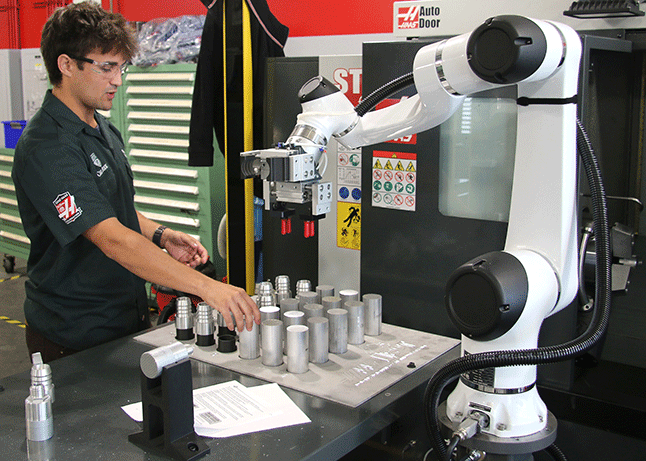 Lab tech works with Haas machine in lab