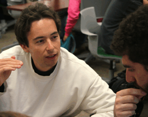 Researcher talks with student in lab