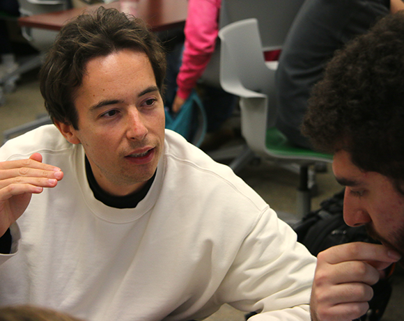 Researcher talks with student in lab