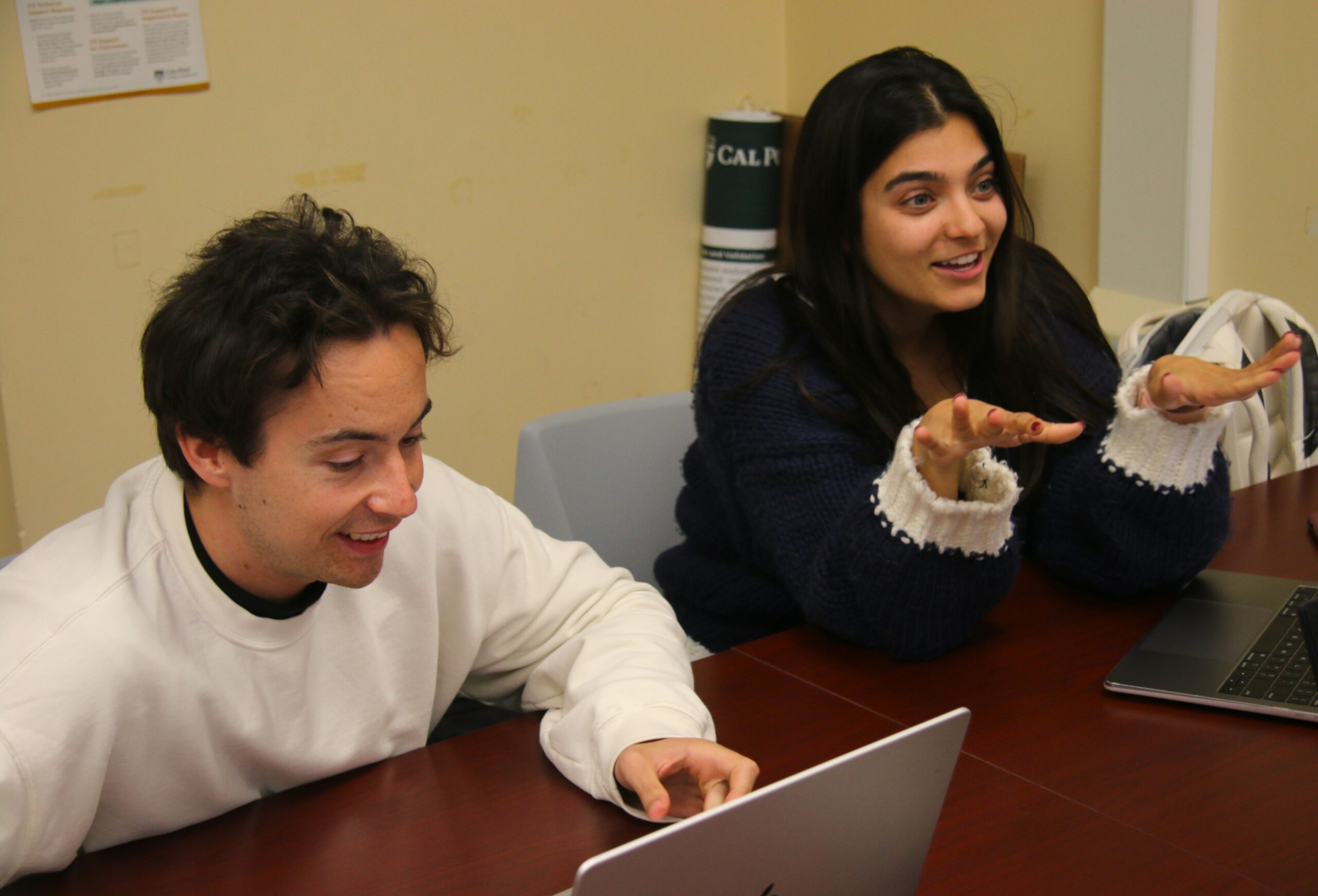 Researcher talks with student in lab
