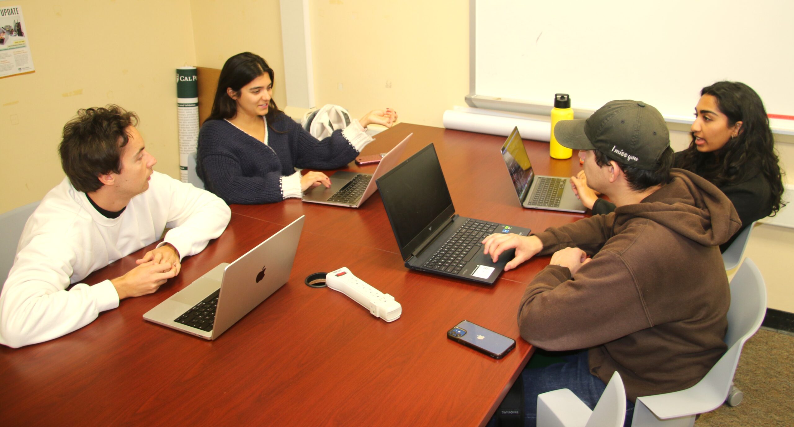 Researcher works with students in lab