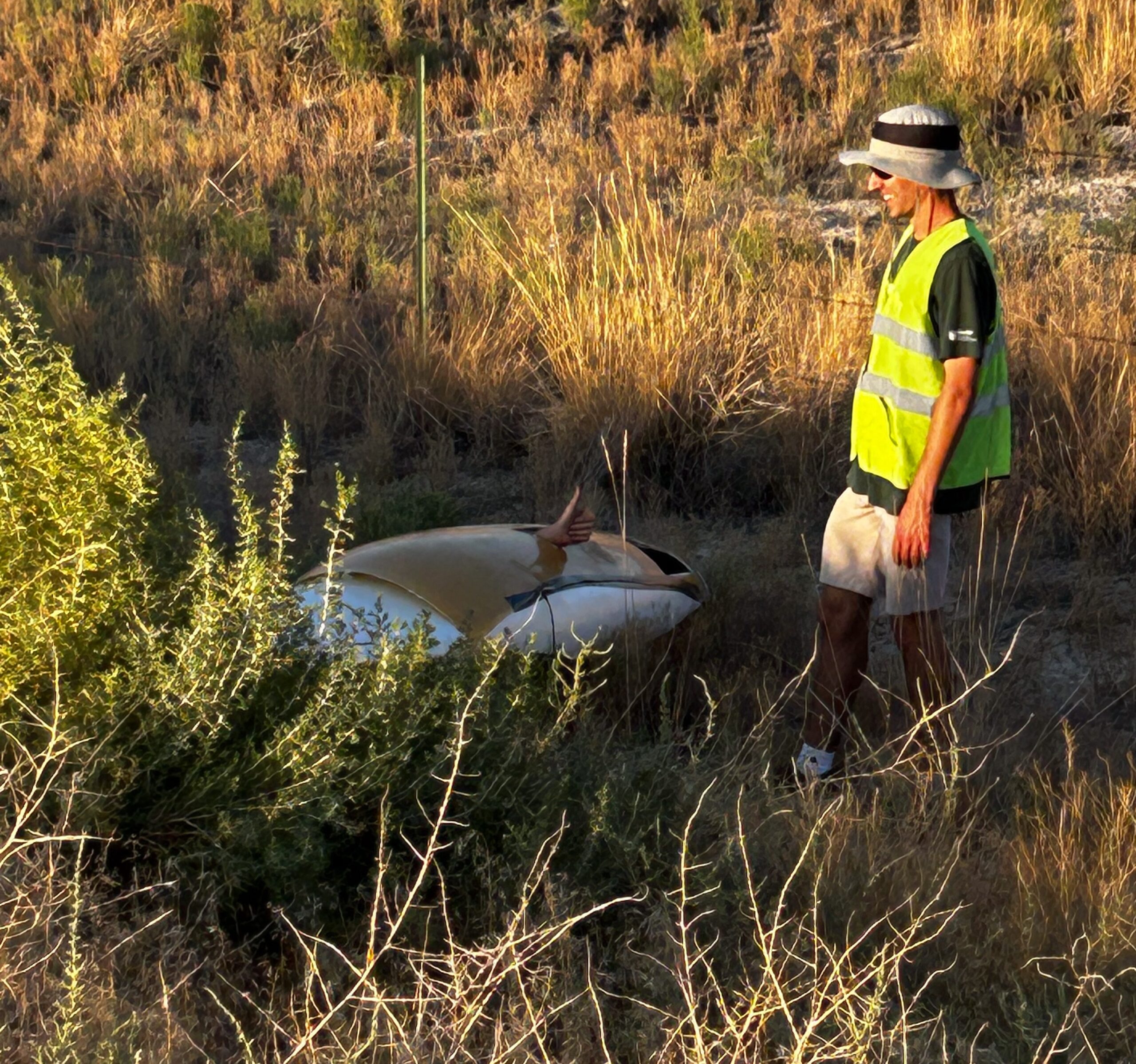 Student gives thumbs-up from inside the vehicle after crashing in the bushes