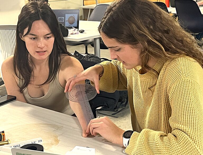 Students measure for prosthetic