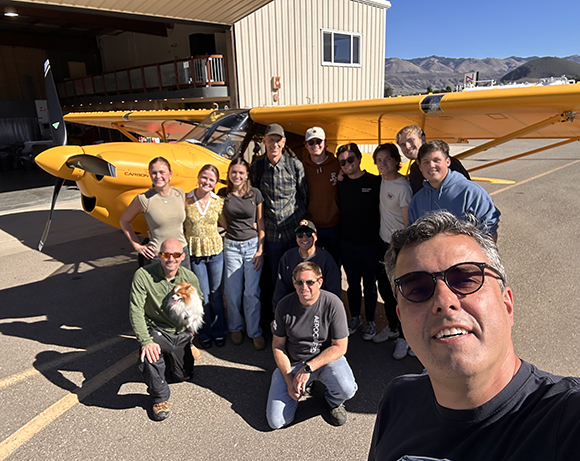 Paulo poses with his students in his flight test class and flight crew along with the record-breaking plane.