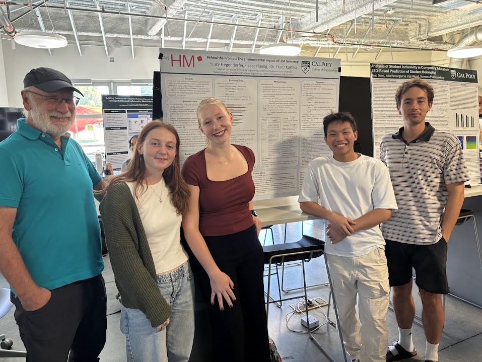 Students, professor and researcher display poster during SURP showcase. 