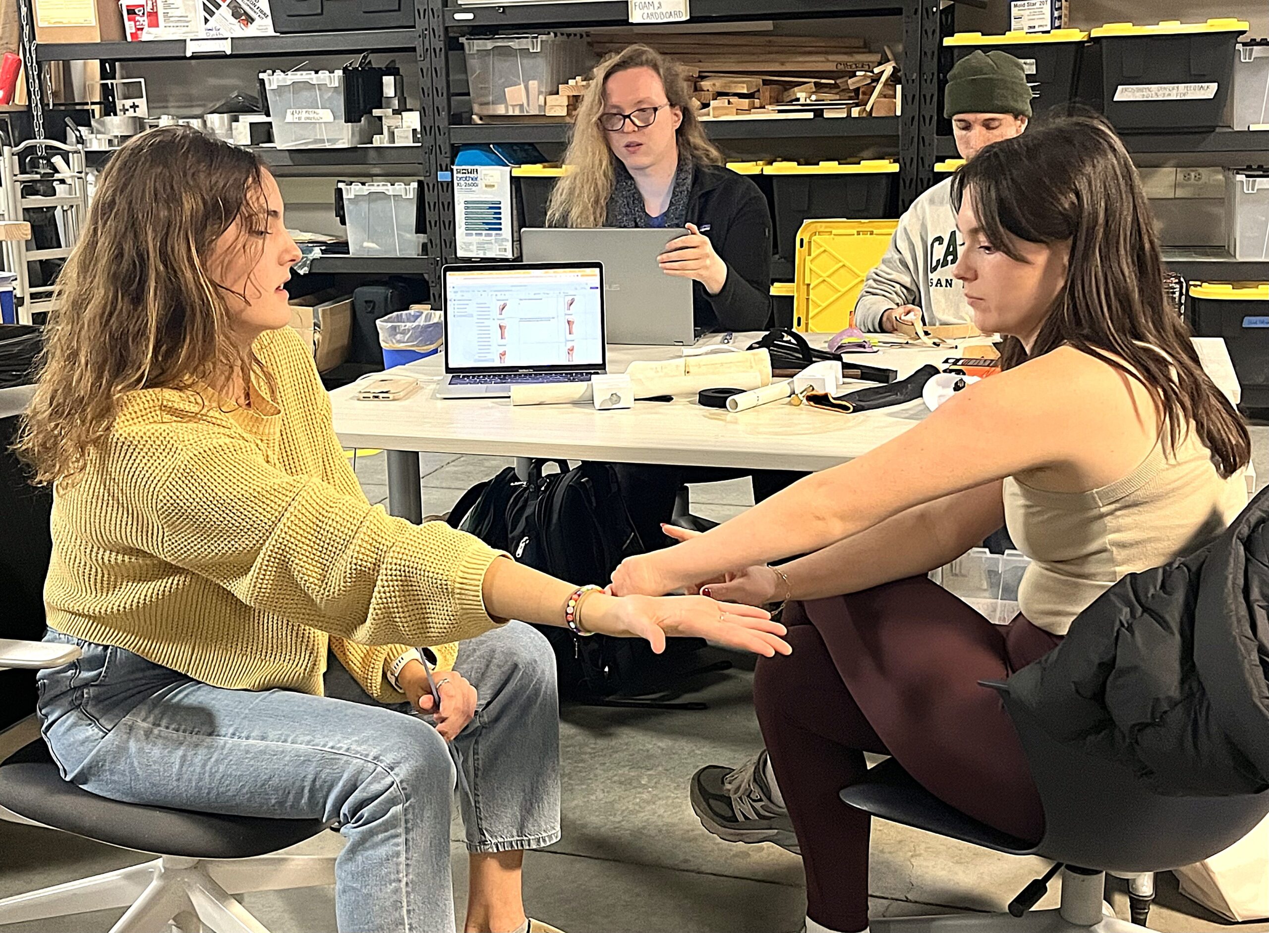 Students work in group while discussing prosthetic