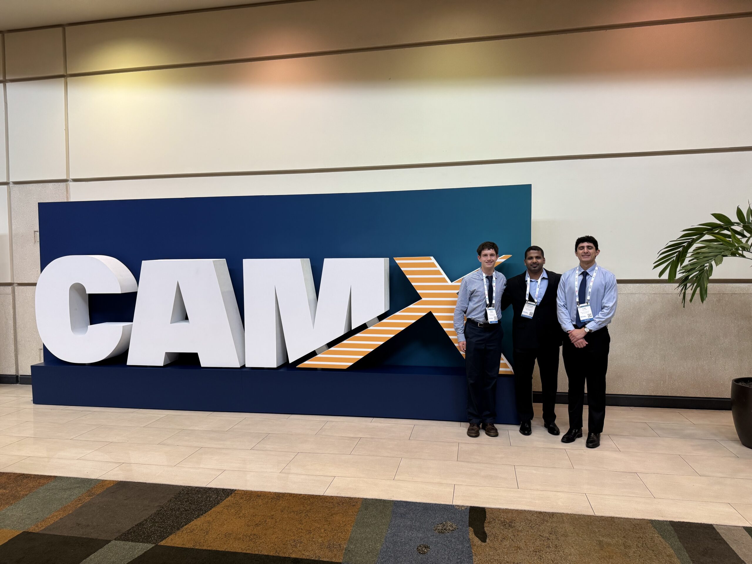 Three people at a conference