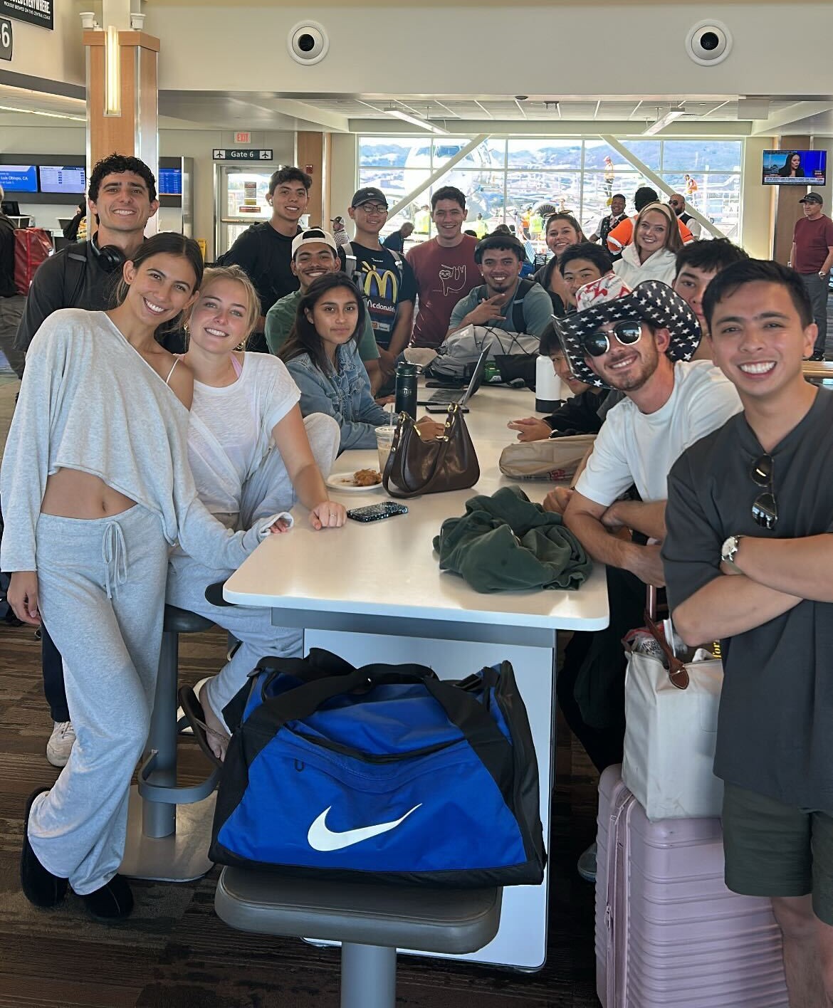 Students gather for photo at the airport