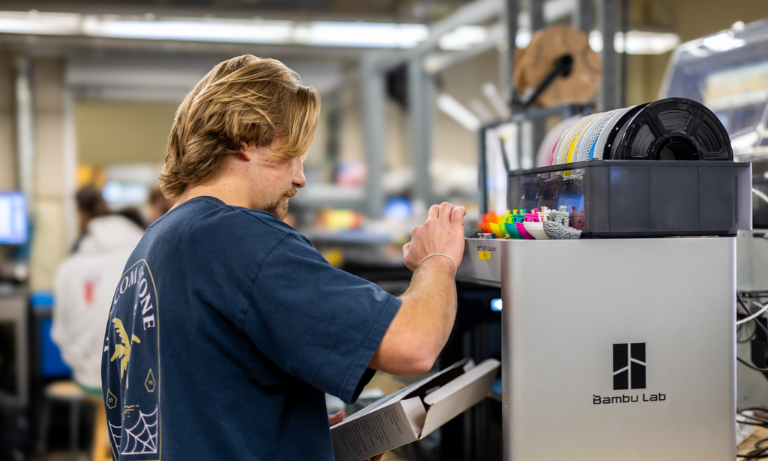 A student working on a digital fabrication machine
