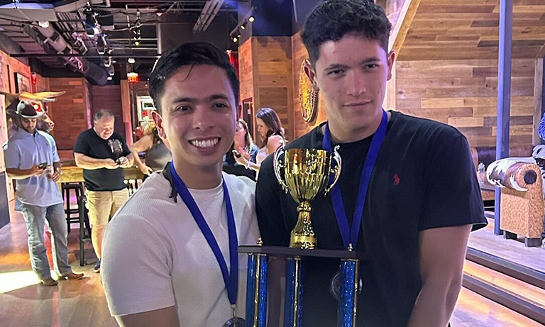 Students hold trophy at competition