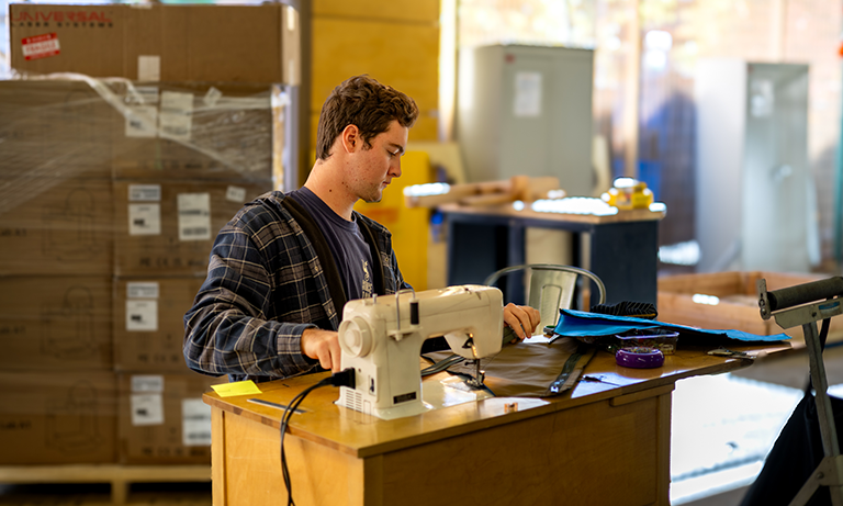 Student uses sewing space in makerspace