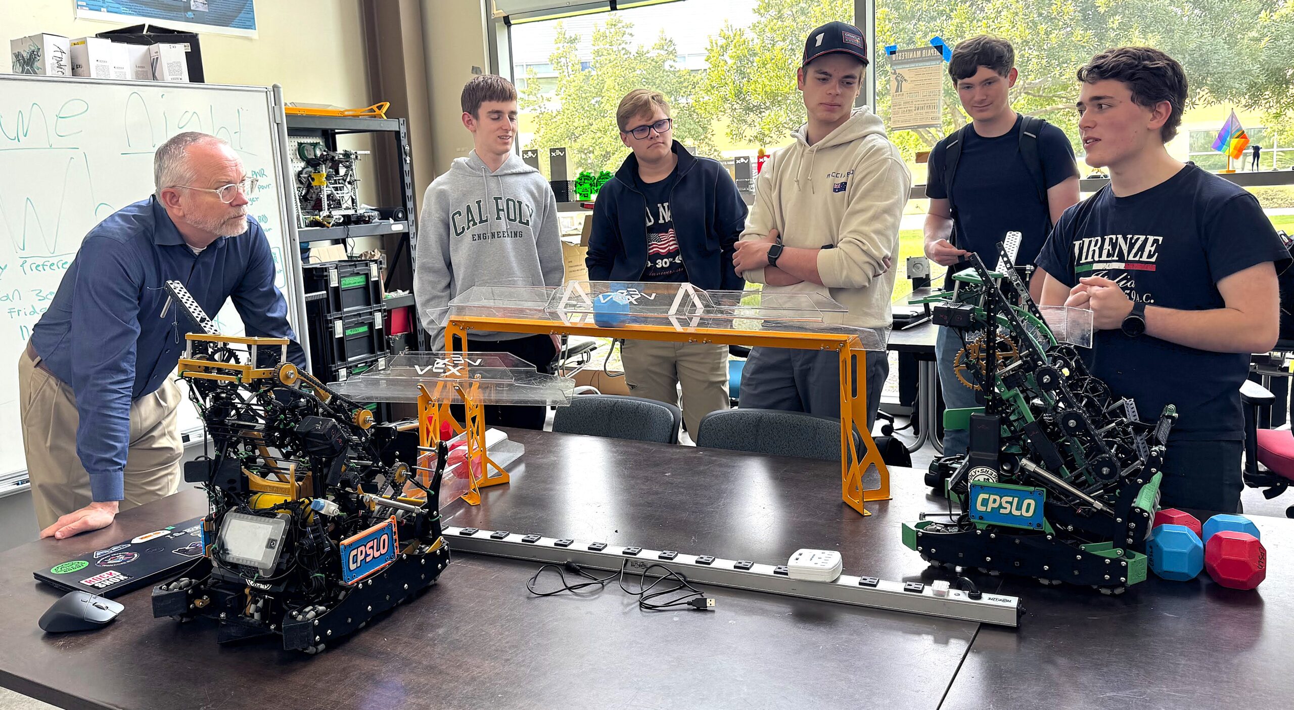Dean checks out robots with team members