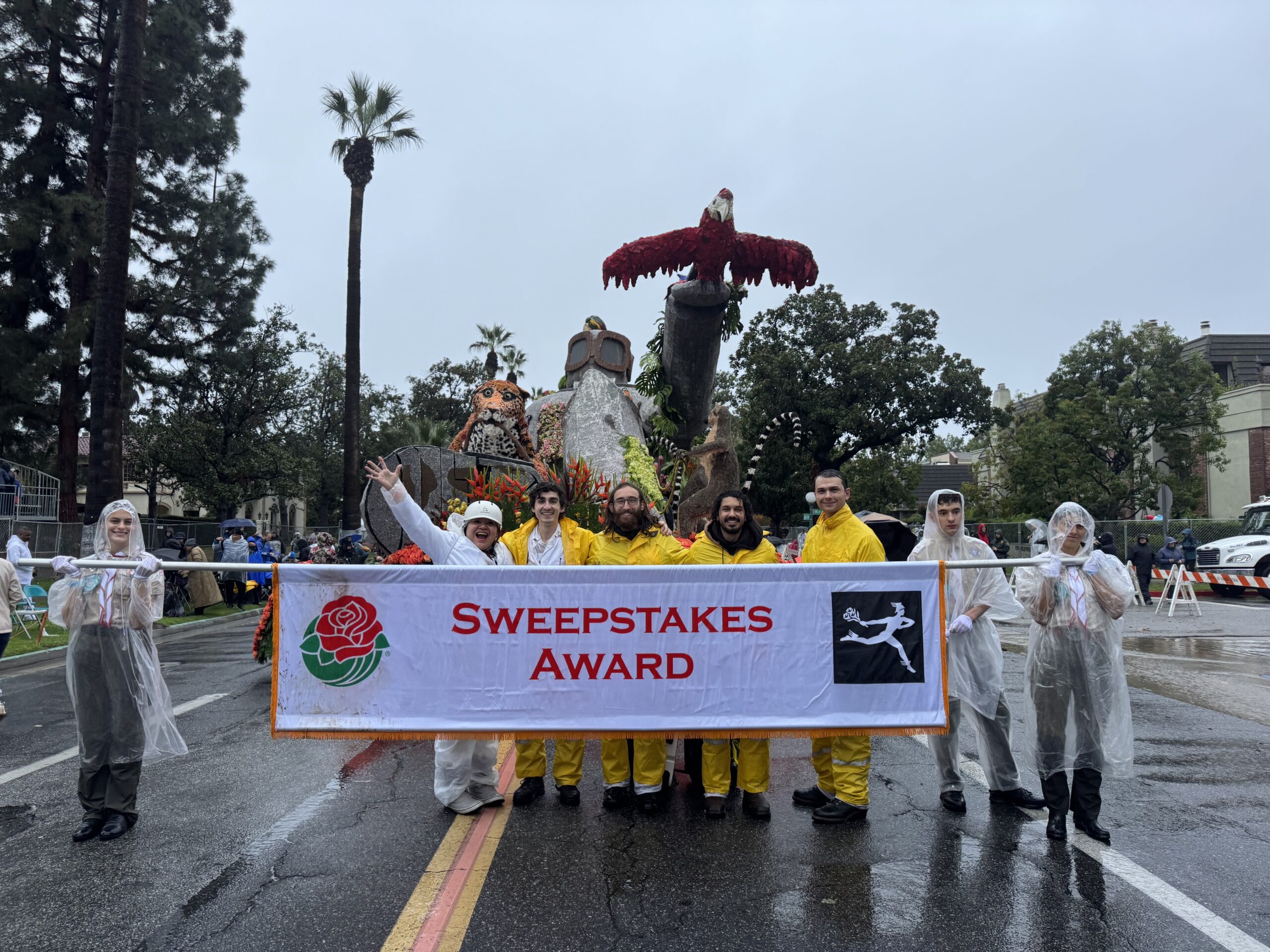 Group stands in front of the Rose Float entry